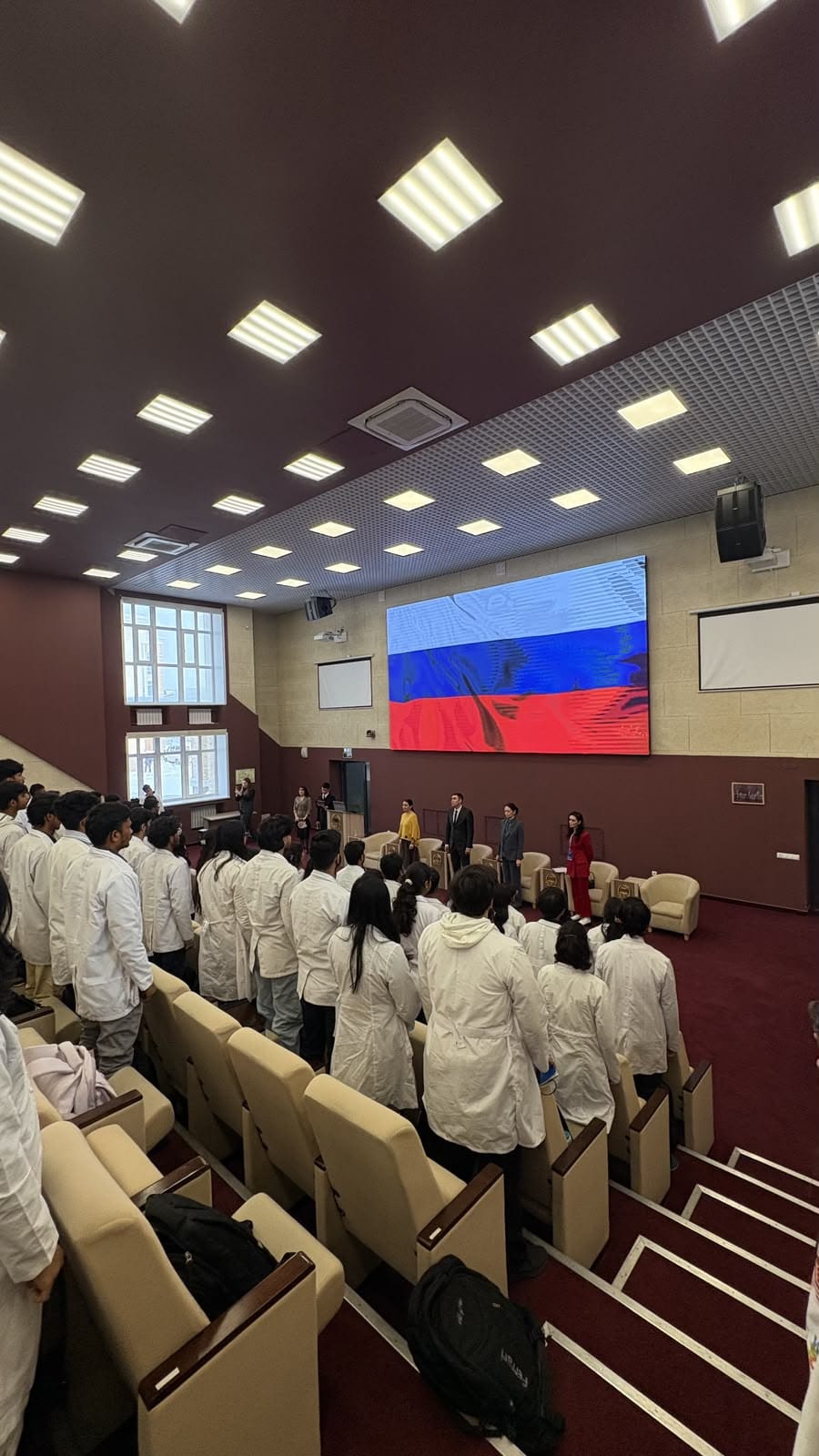 Scrubs & Stories students in white coats at a Russian medical university ceremony
